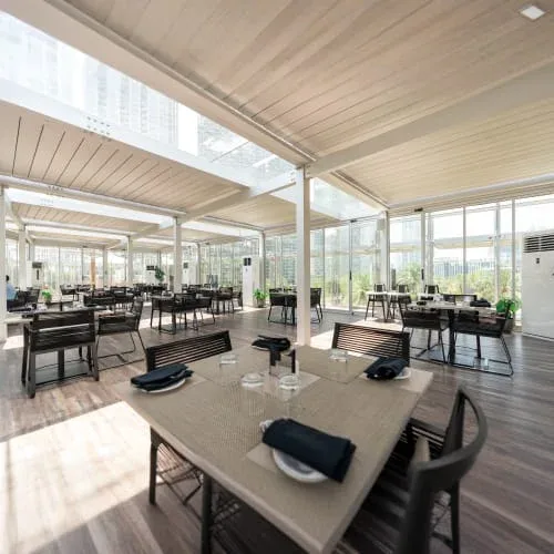 Bright indoor restaurant dining area at The Rooftop Burj Club in Dubai