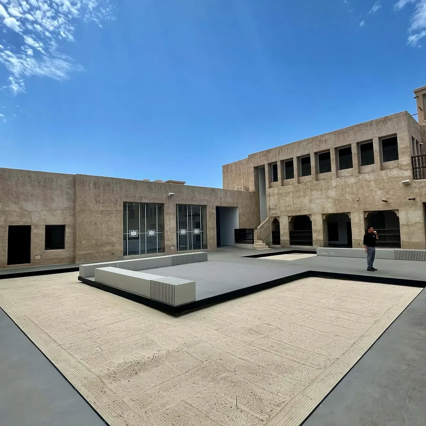 Al Shindagha Museum courtyard with traditional Dubai architecture under a clear blue sky
