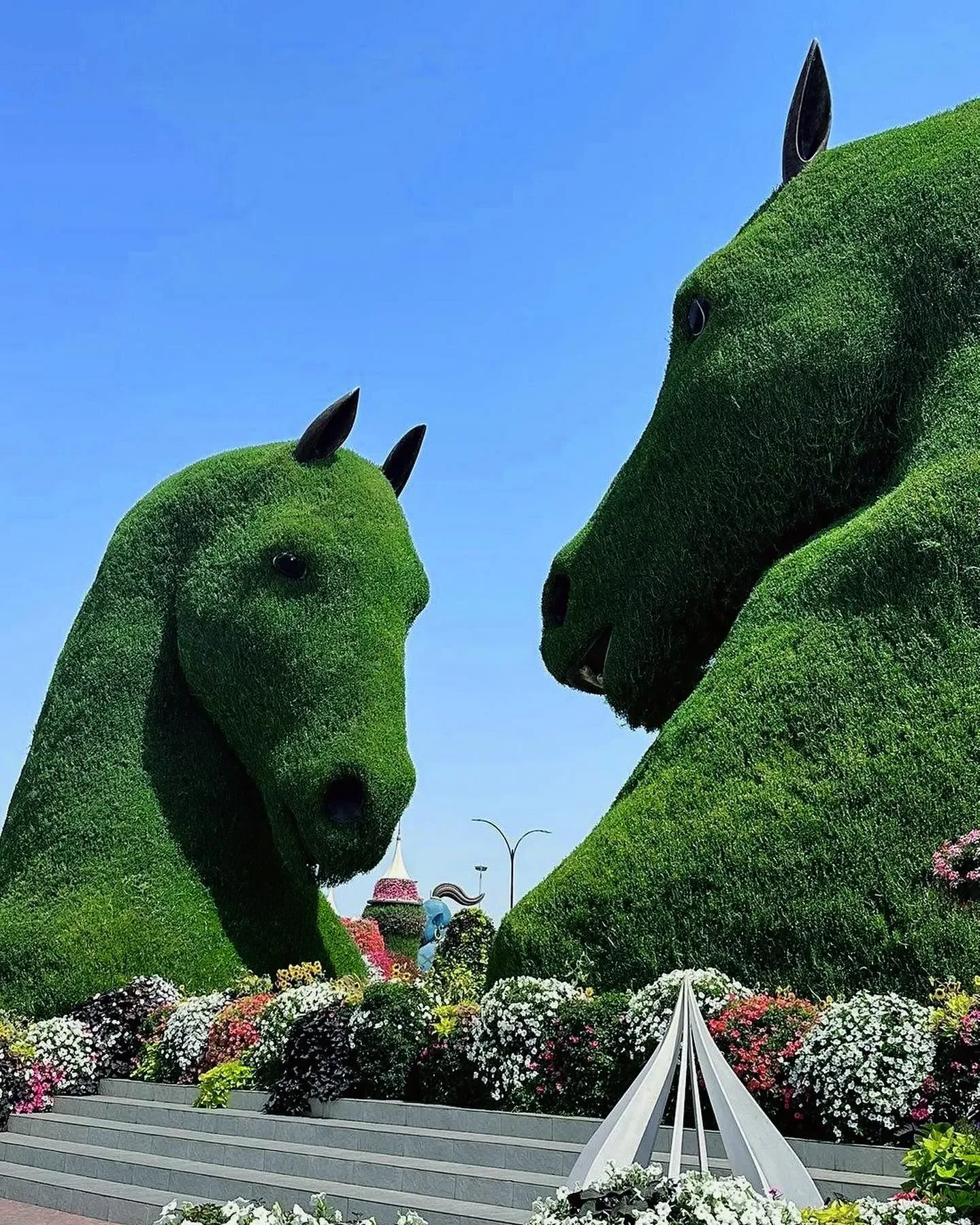 Large green horse-shaped floral sculptures at Dubai Miracle Garden
