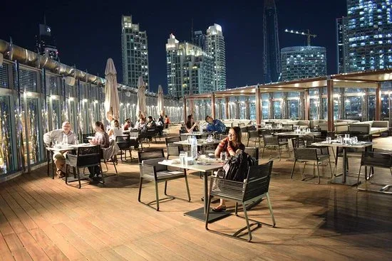 Rooftop dining area with Dubai skyline views at The Rooftop Burj Club