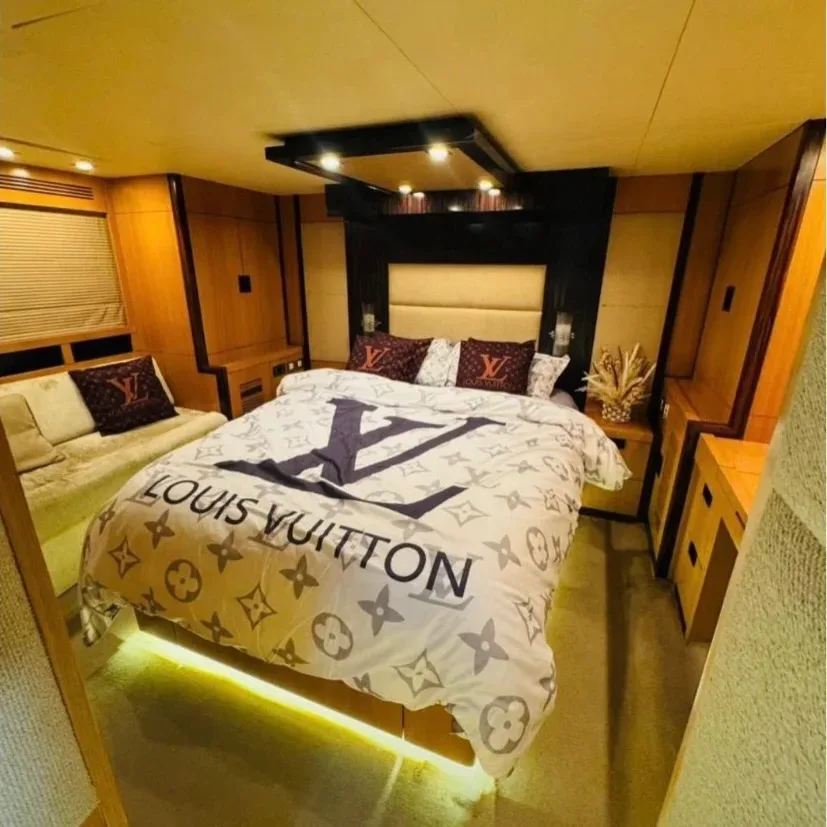 Luxury yacht bedroom with comfortable bed on a private Dubai charter