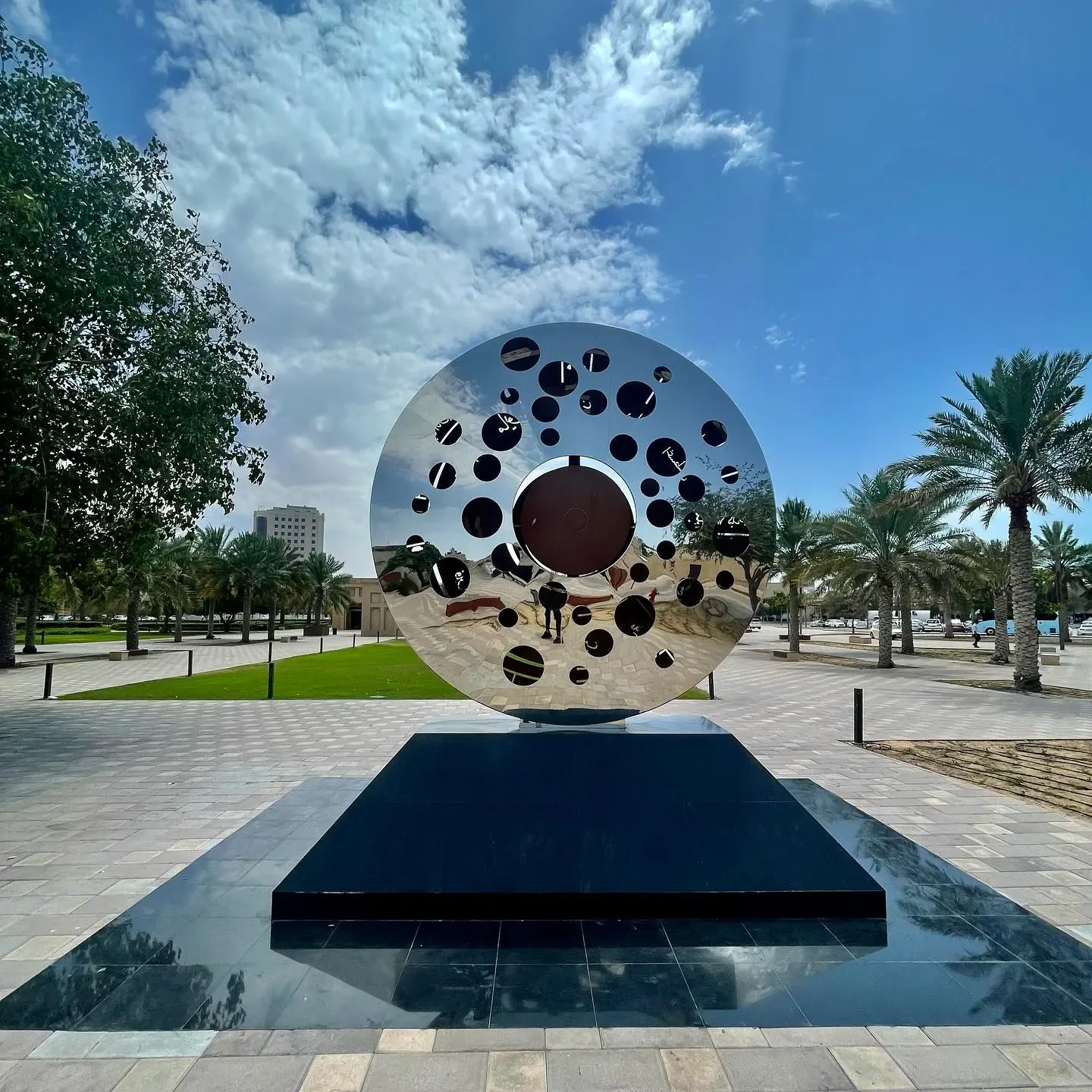 Outdoor public artwork surrounded by palm trees in the Al Shindagha heritage district