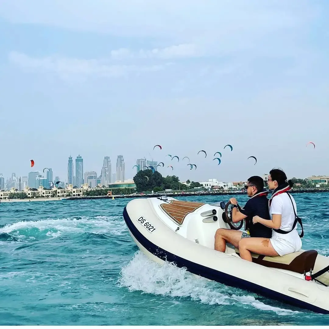 Speedboat ride with Dubai skyline and water sports activities in the background
