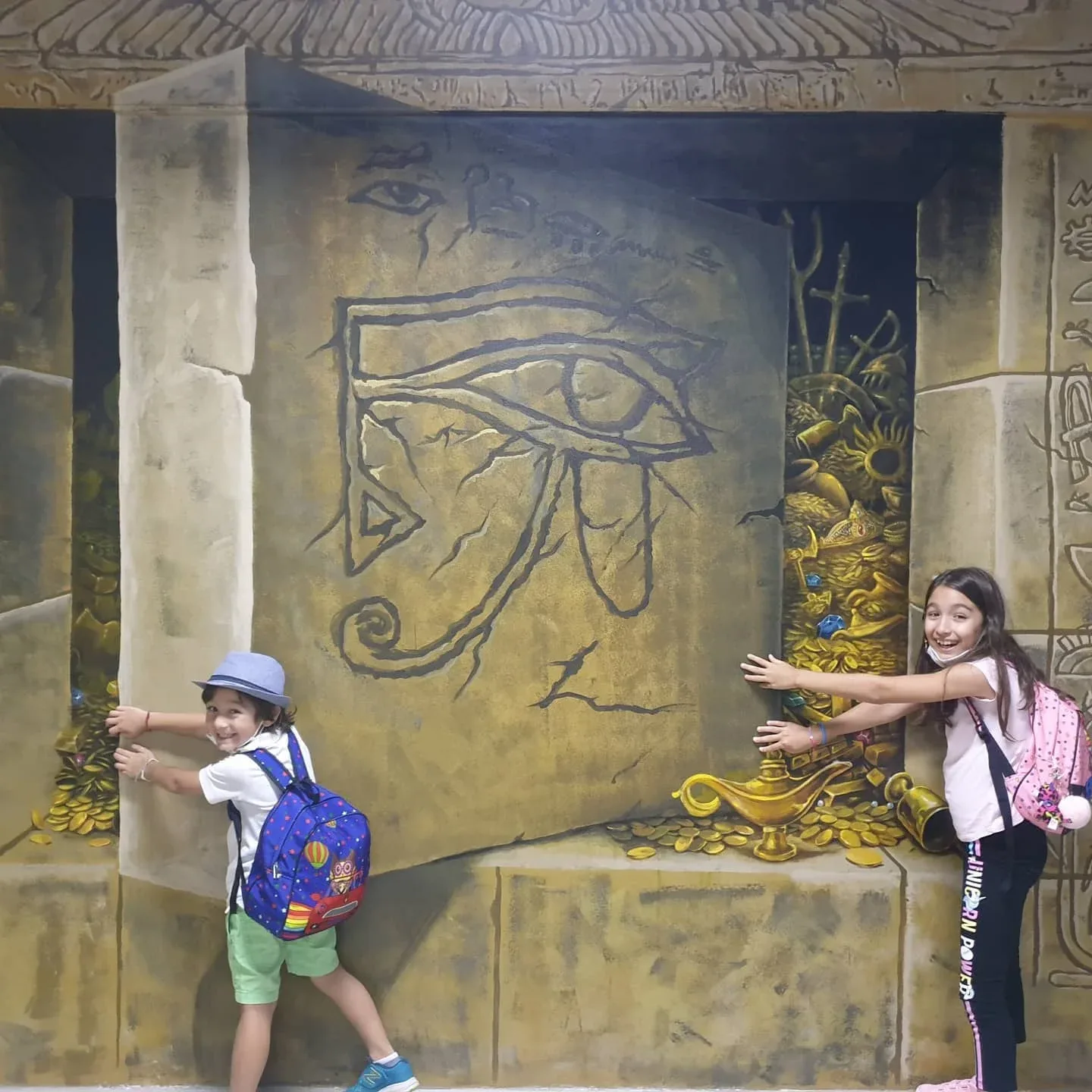 Children posing with Egyptian 3D wall art at 3D World Selfie Museum Dubai
