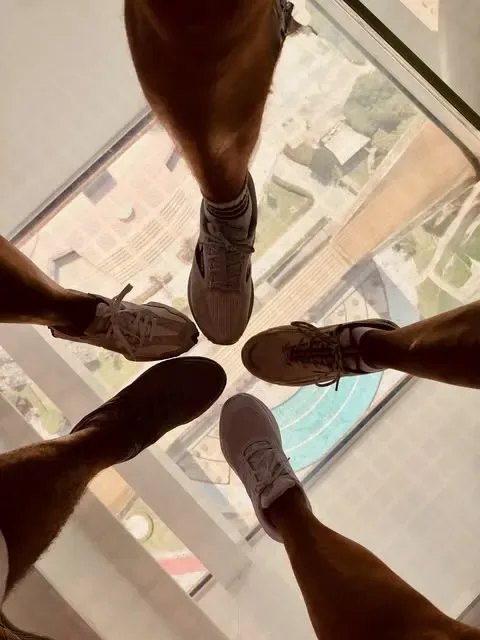 Visitors standing on the glass floor inside Dubai Frame