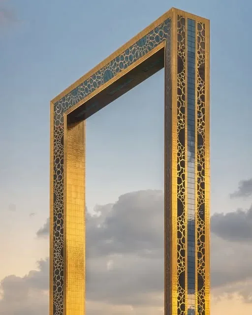 Close-up view of the golden Dubai Frame structure against the sky