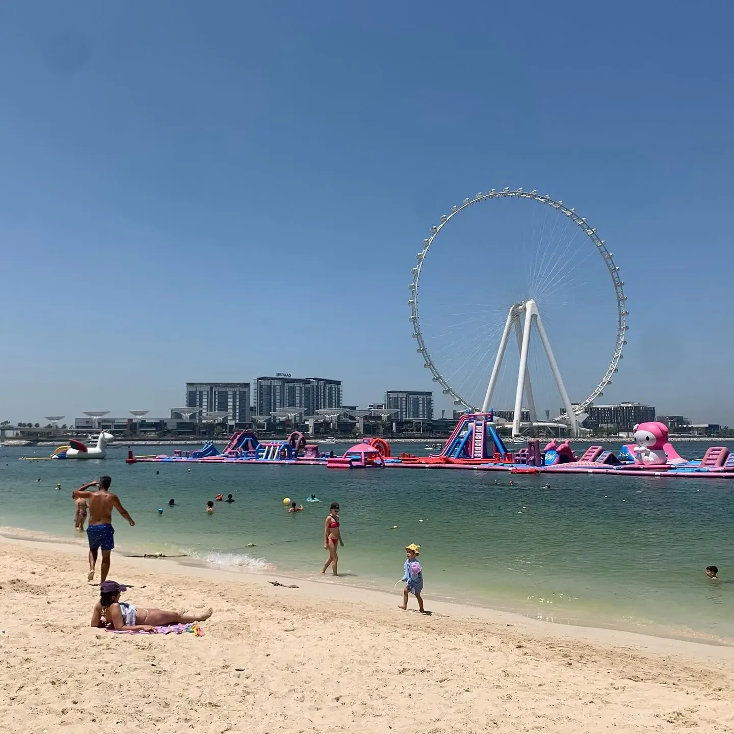 Aqua Fun Dubai inflatable water park with visitors enjoying slides and water activities