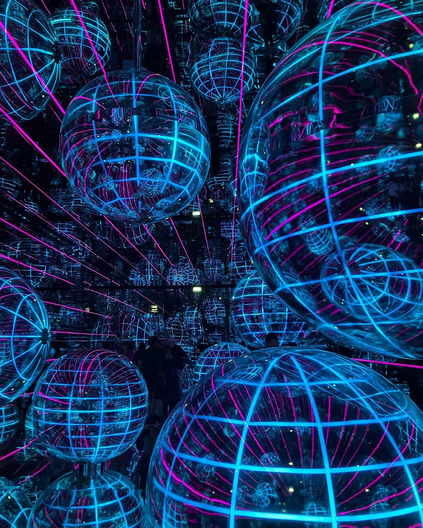 AYA Universe Dubai immersive digital space filled with glowing blue and pink spherical light projections
