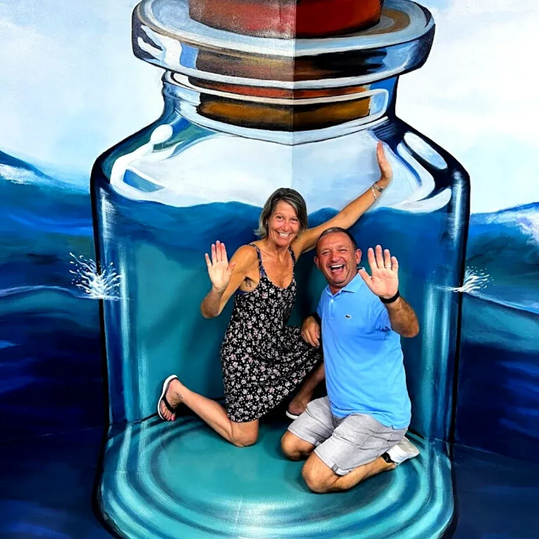 Visitors posing inside giant bottle 3D artwork at 3D World Selfie Museum Dubai