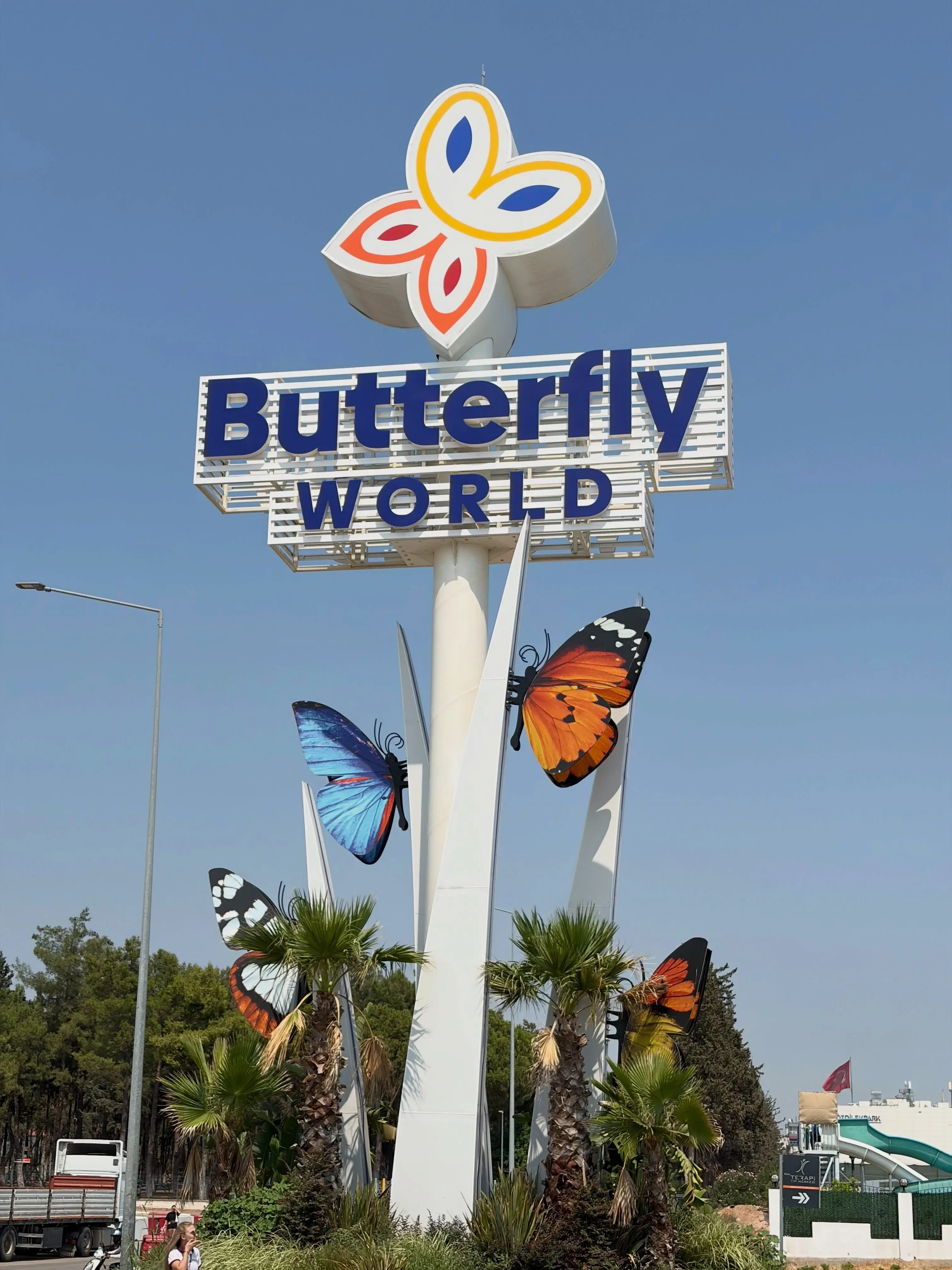 Butterfly World entrance sign with colorful butterfly sculptures in Dubai