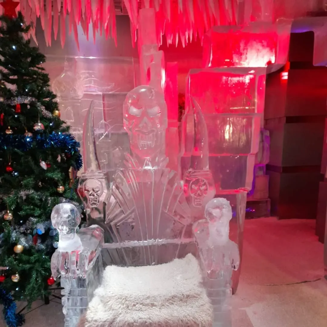 Ice throne and frozen skull sculptures with Christmas decorations inside Dubai Ice Lounge