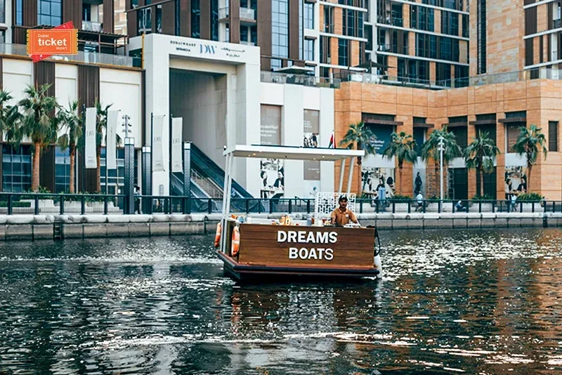 Dream Boats Floating Cafe cruising along Dubai waterfront with city buildings