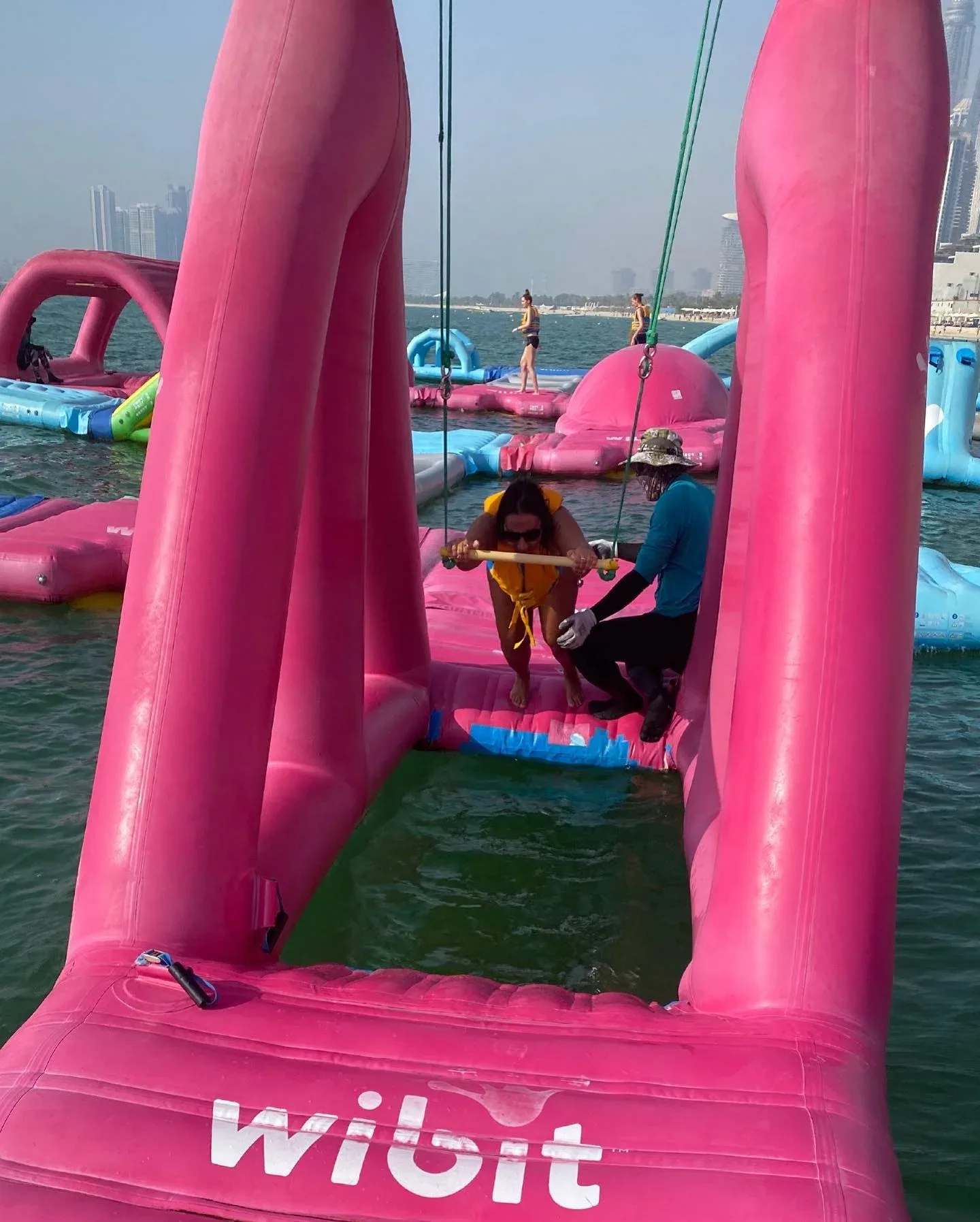 Aqua Fun Dubai inflatable water park at JBR Beach with visitors enjoying water activities