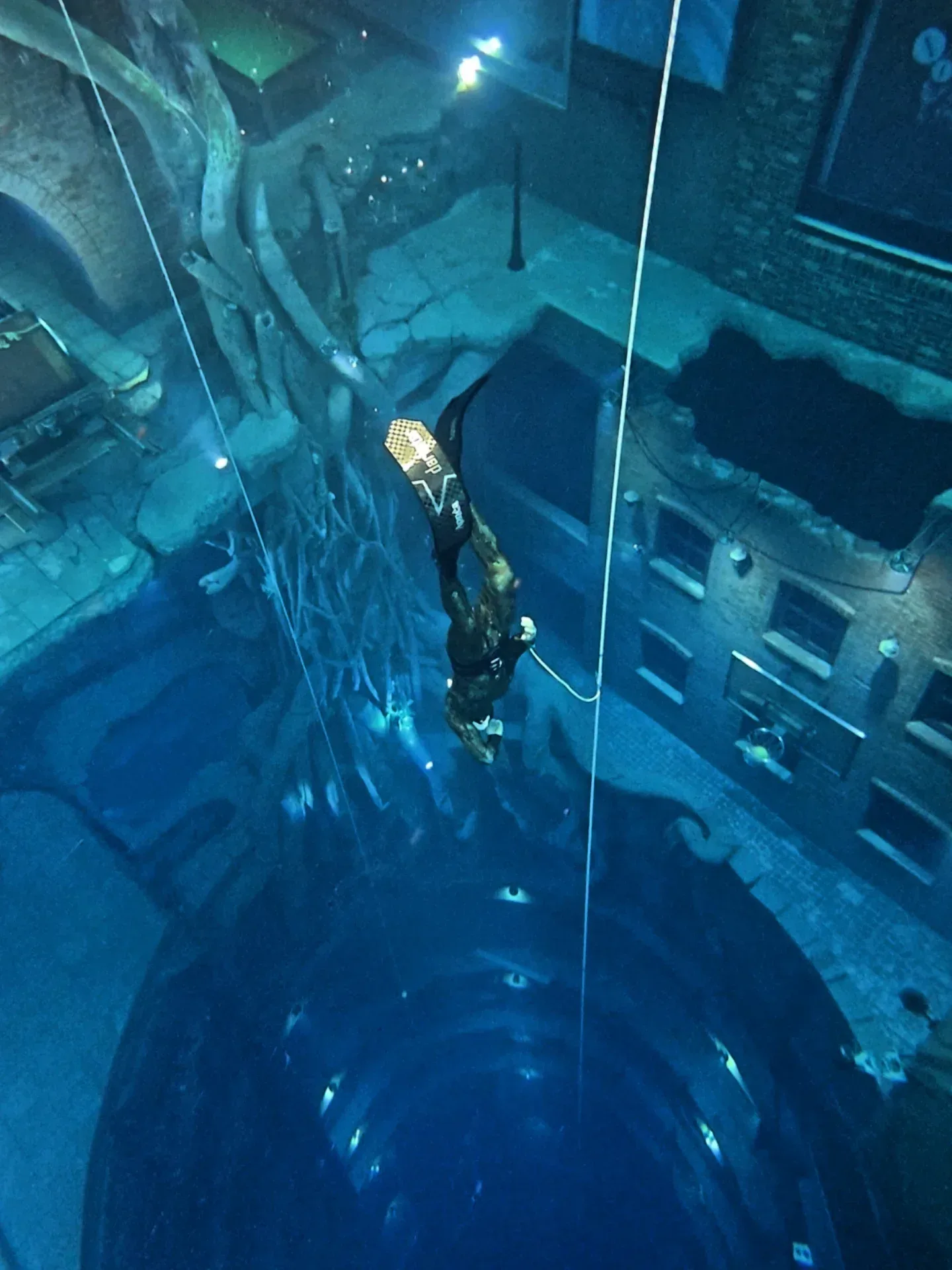 Deep Dive Dubai underwater city with diver exploring submerged structures