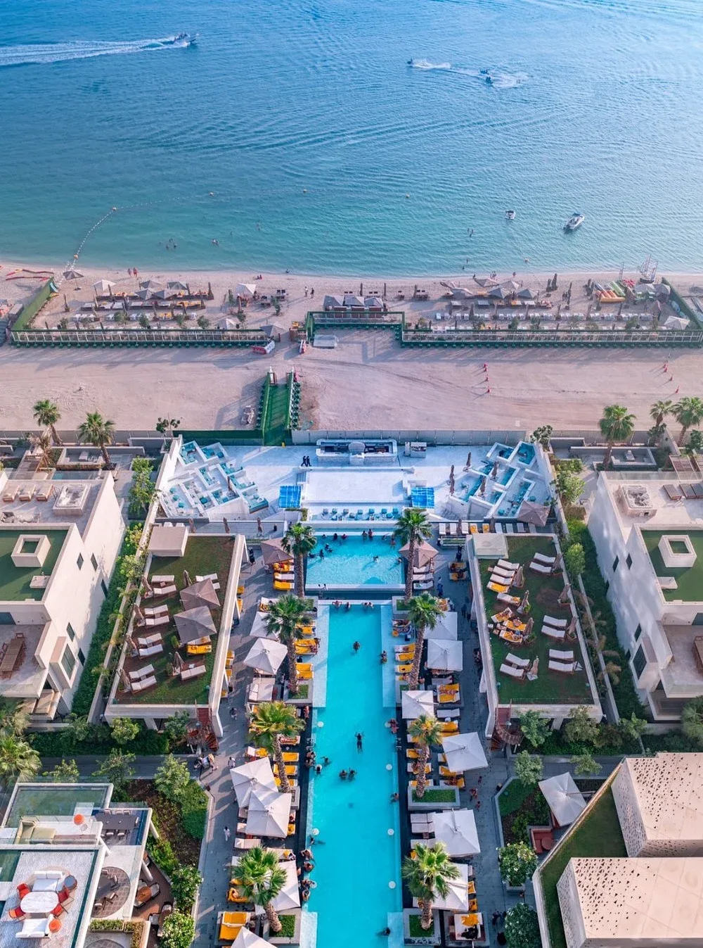 Aerial view of a luxury Dubai beach resort with swimming pool and Arabian Gulf