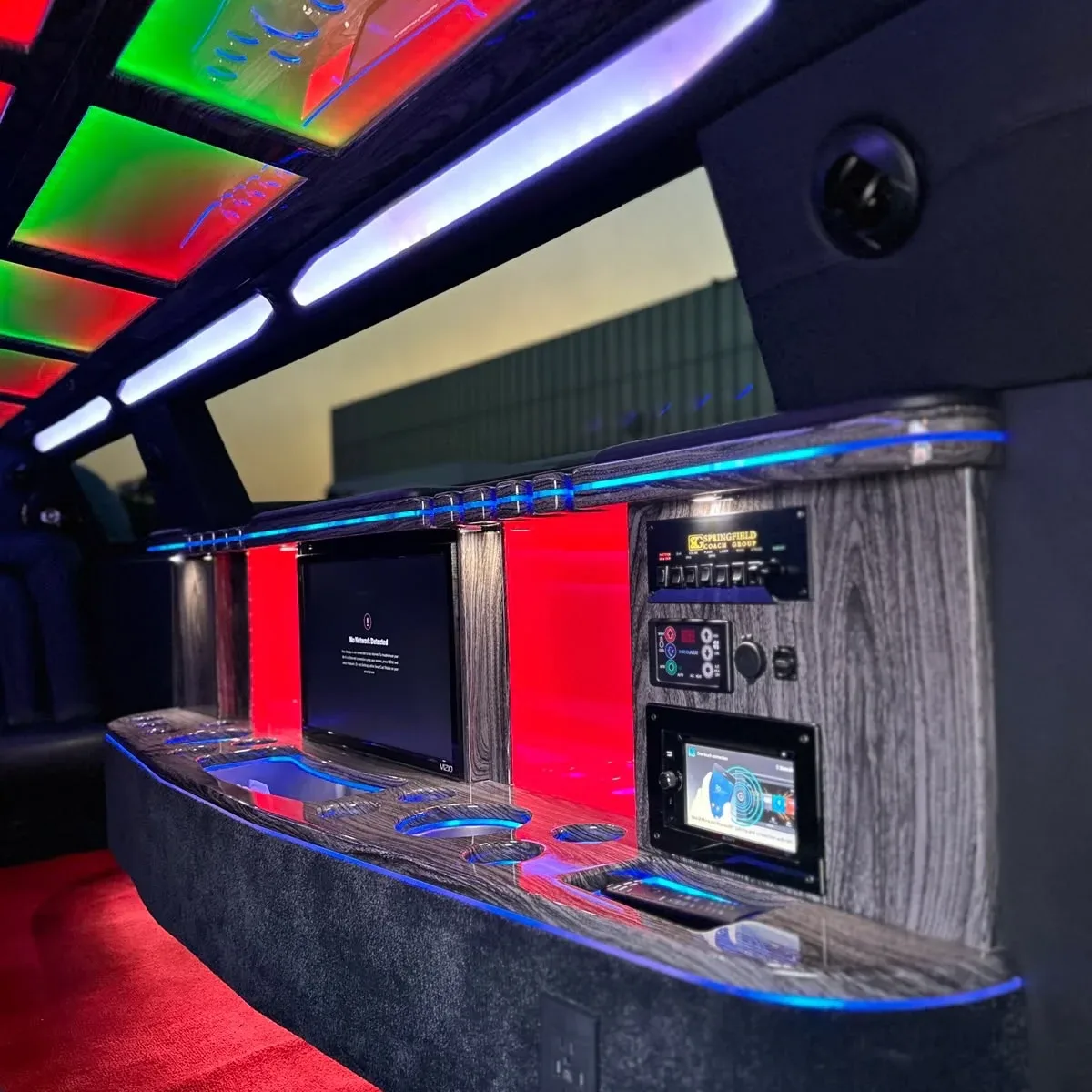 Luxury limousine interior with colorful LED lighting and entertainment system