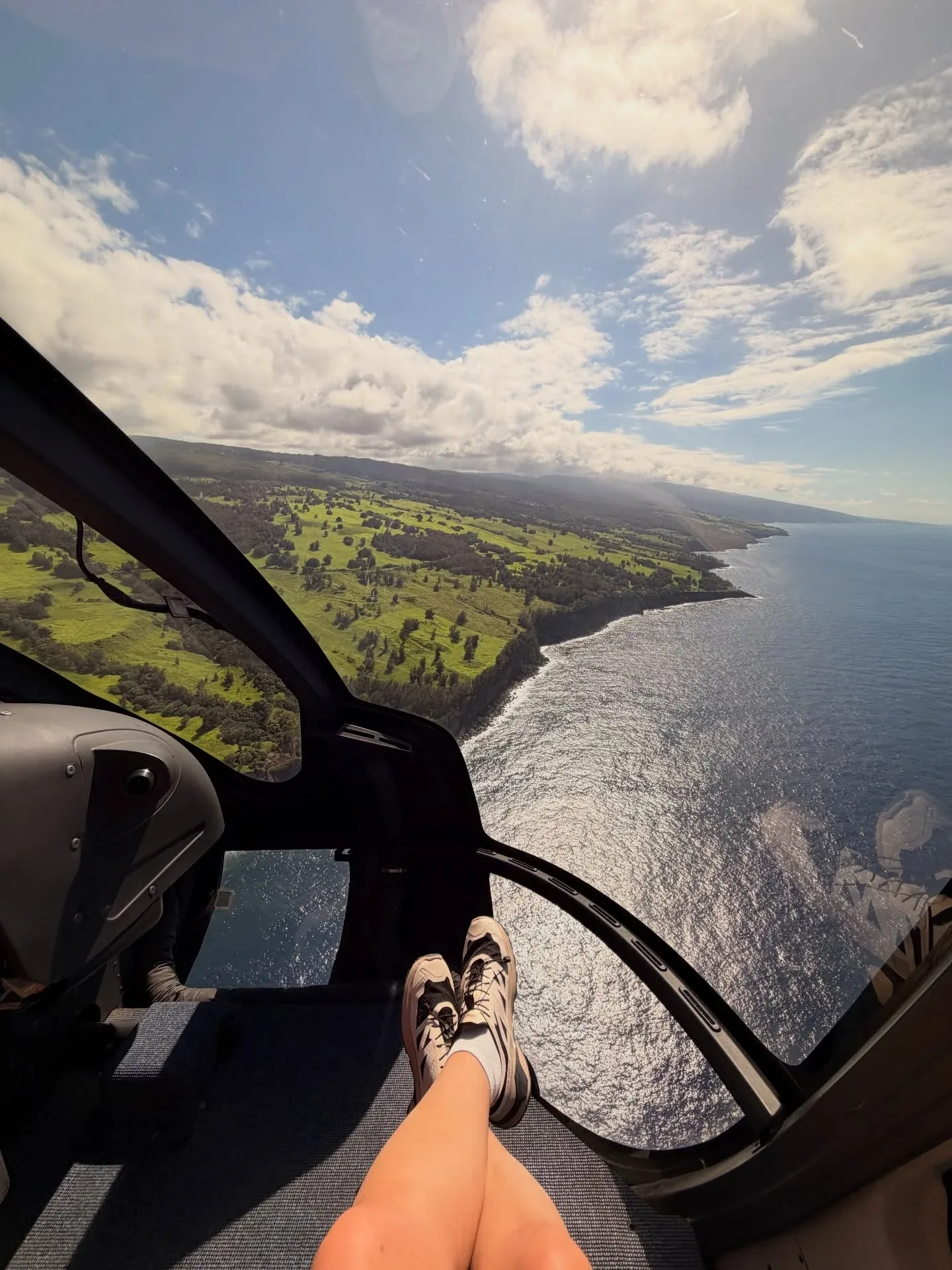 Helicopter flying over a scenic coastline with ocean views