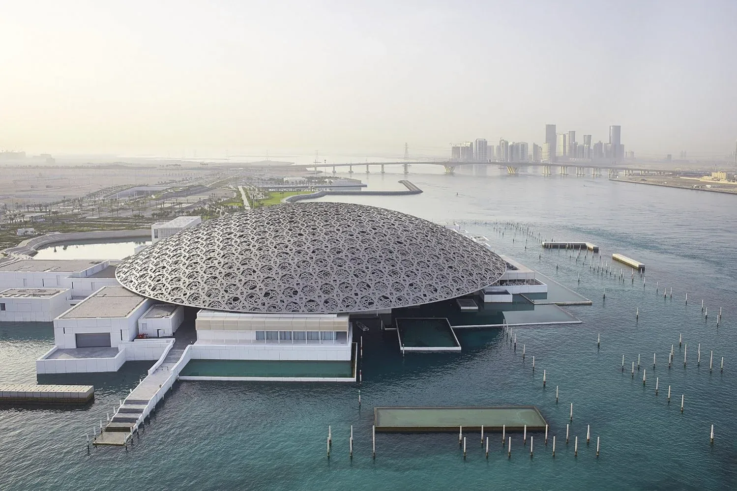 Louvre Abu Dhabi aerial view with waterfront and iconic dome in Abu Dhabi
