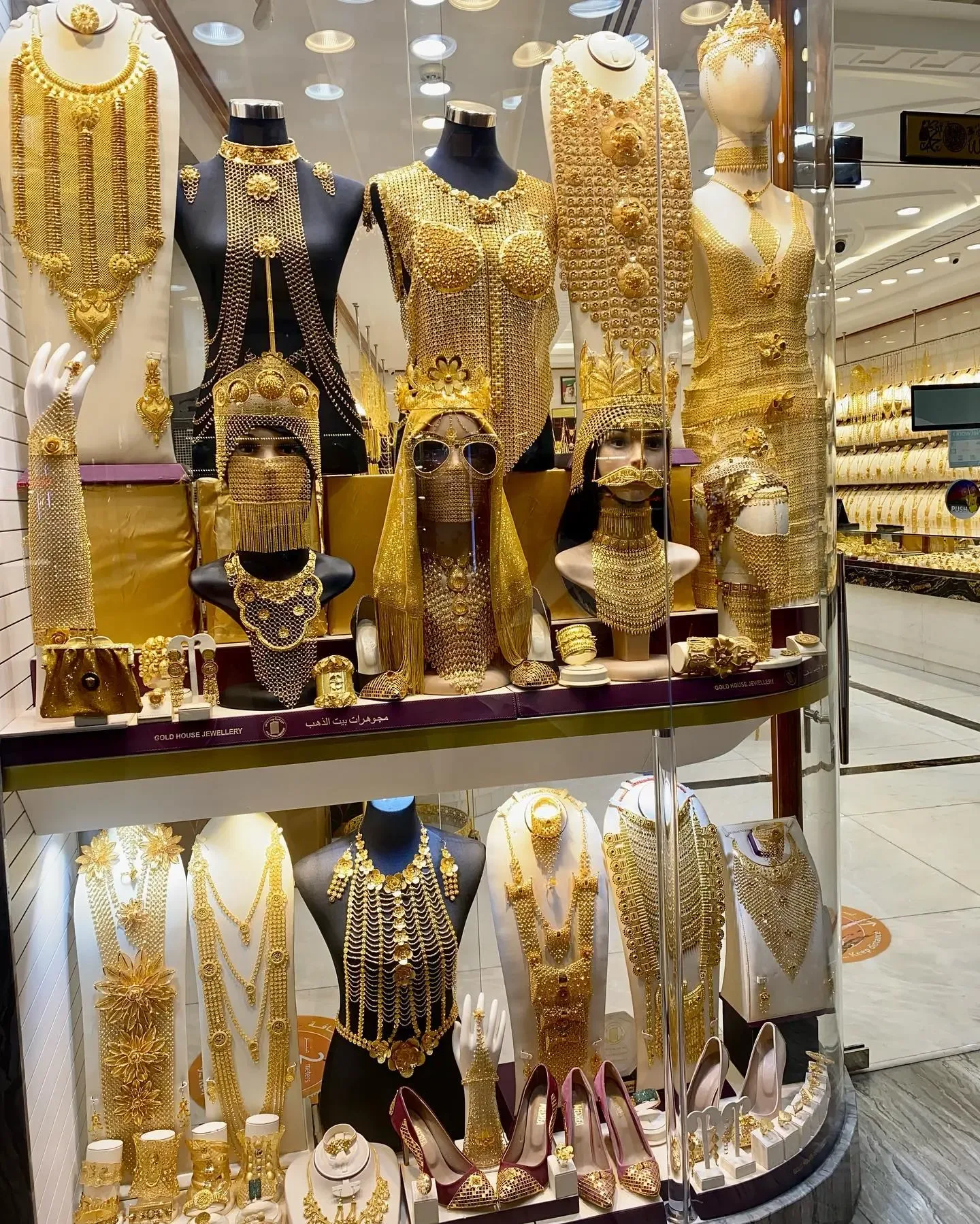 Gold jewellery displayed in a Dubai shopping store with necklaces and traditional designs