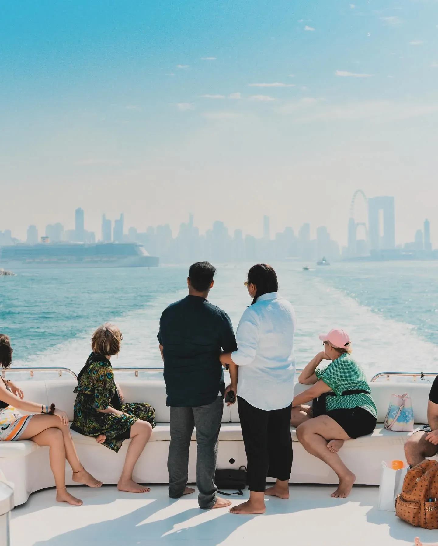 Family enjoying Xclusive Shared Yacht Tour Dubai with Dubai skyline views