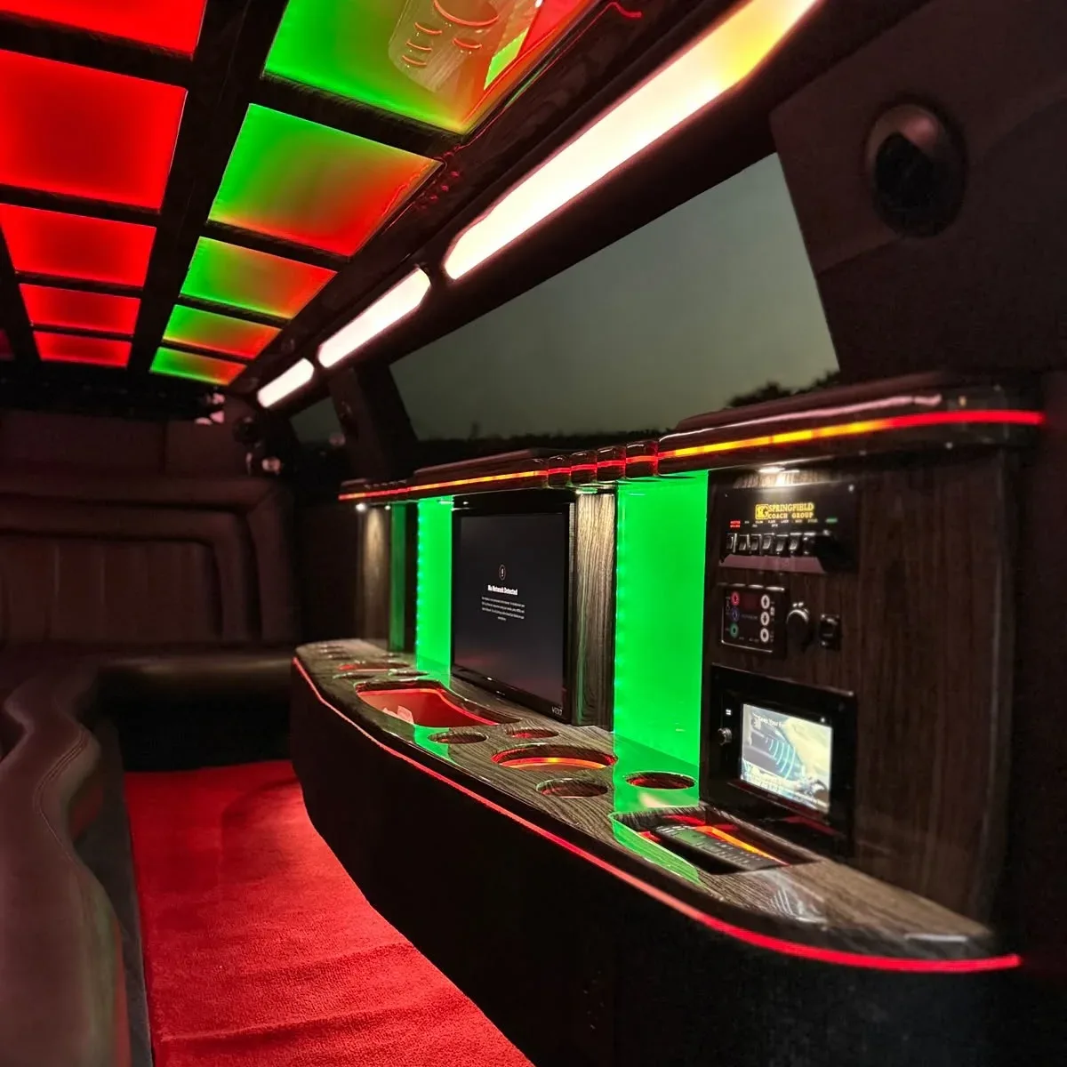 Premium limousine interior with red and green ambient LED lighting