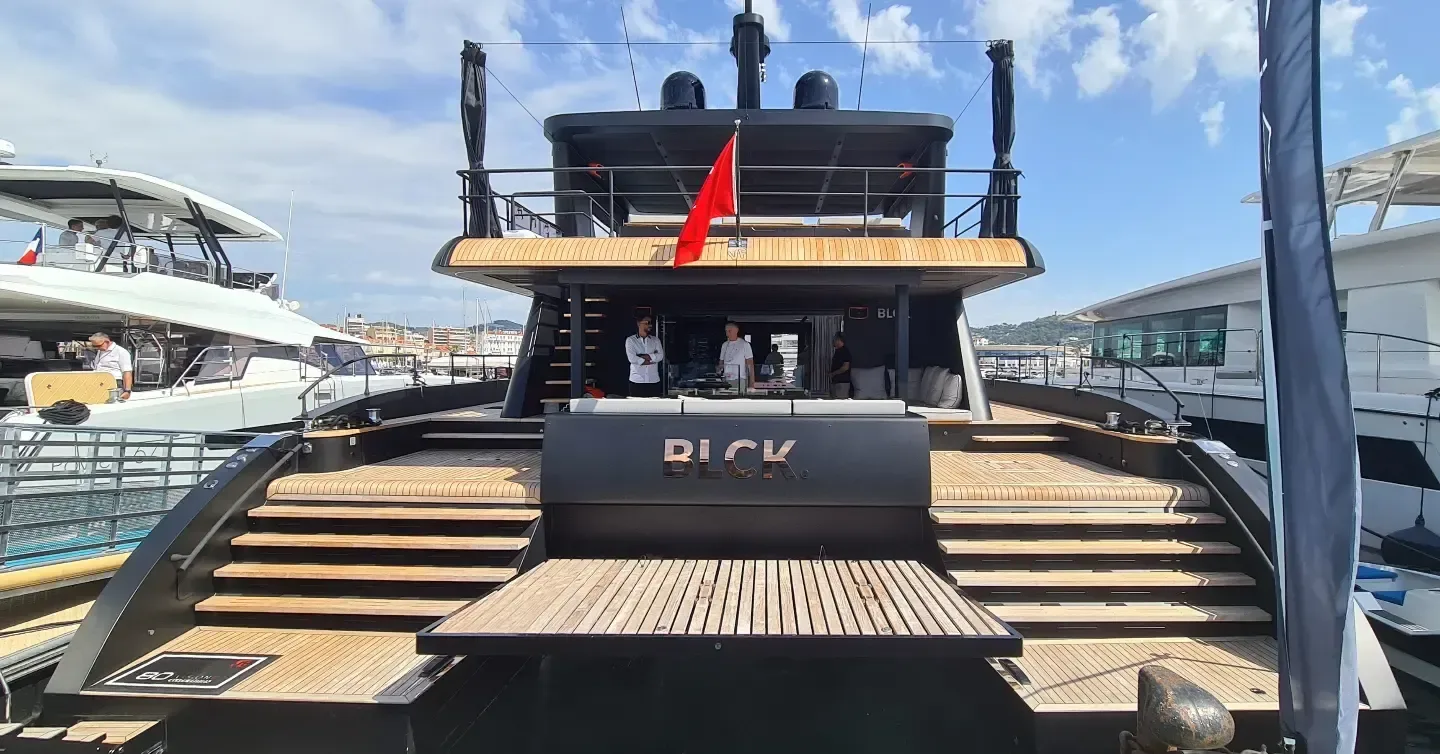 Black Boat Tours luxury boat docked at a marina with spacious deck