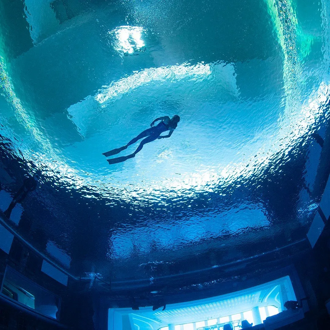 Diver swimming underwater at Deep Dive Dubai