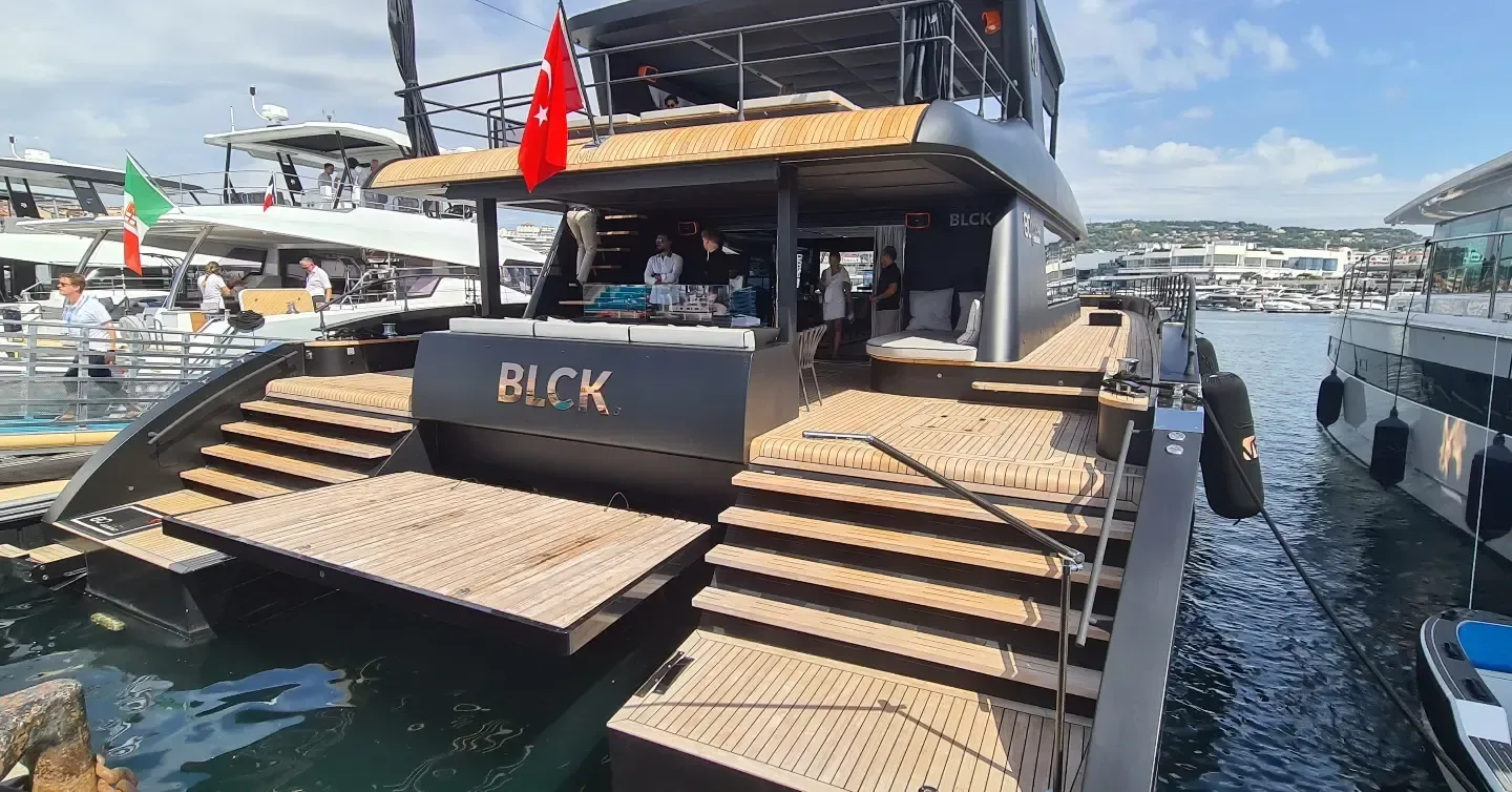 Black Boat Tours premium boat with outdoor seating at the marina