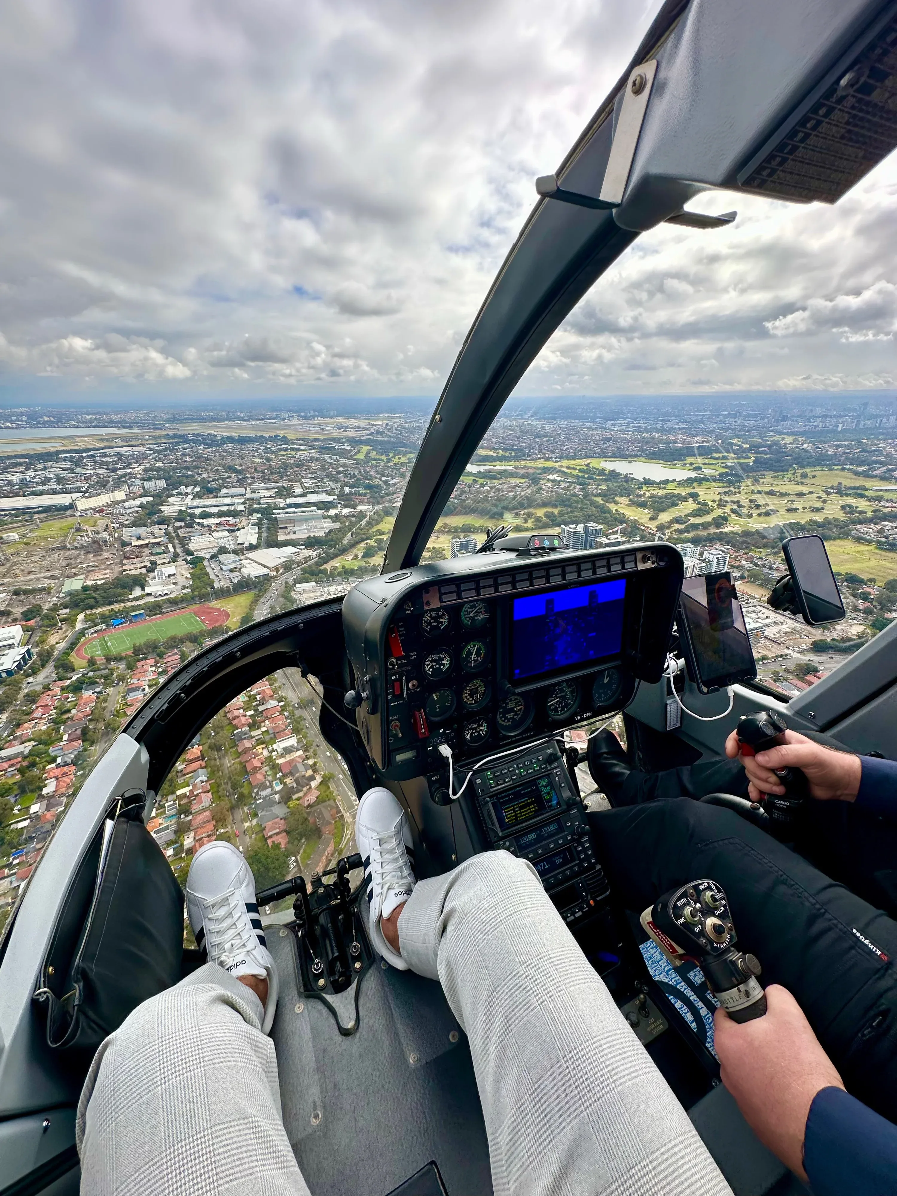 Helicopter cockpit view of city and landscape from above